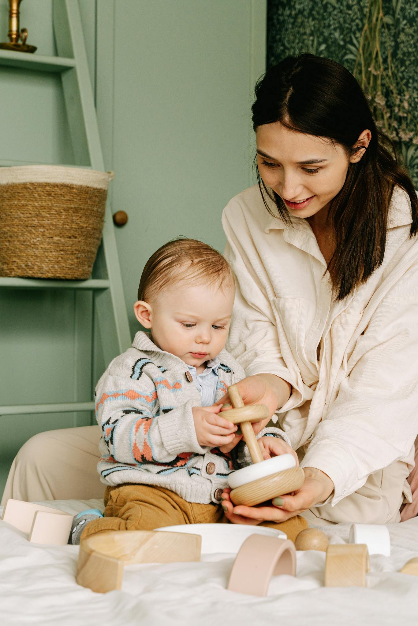 a mother and baby play together with